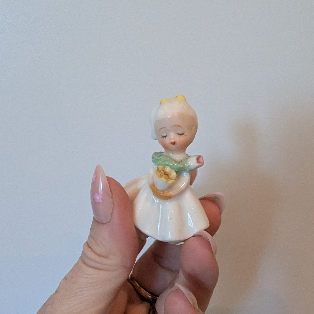 Small Girl Porcelain Figurine with Yellow and Green Accents